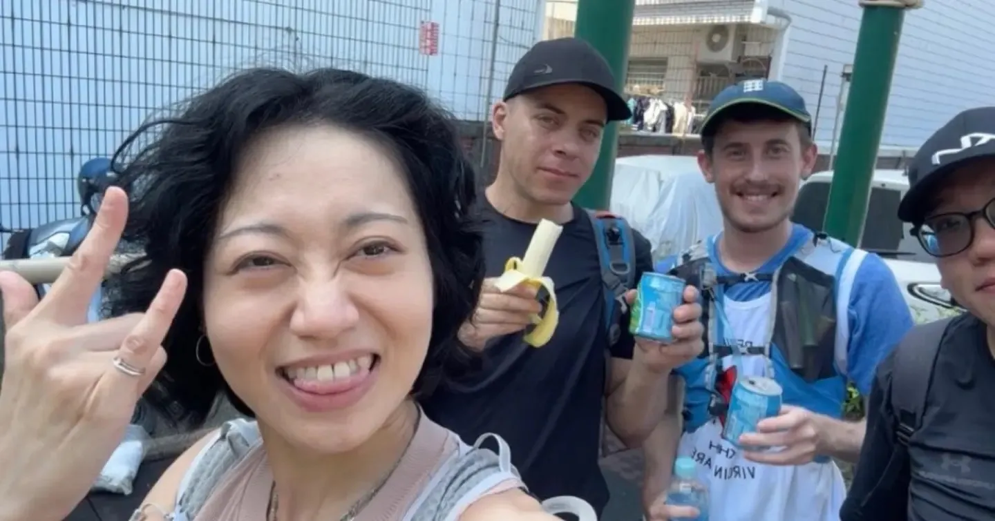 Harry with fellow hashers on the trail, holding a banana and cans of drink