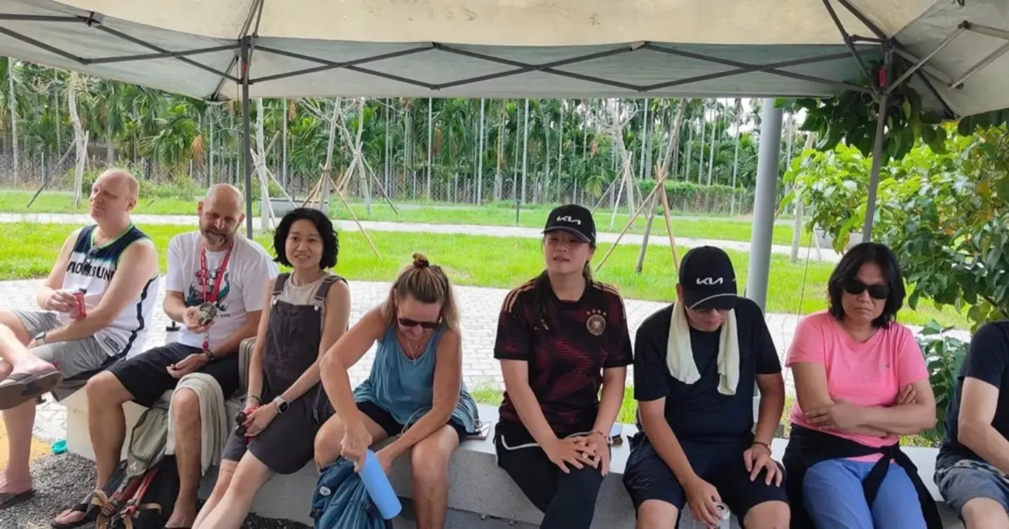Hashers resting together in the shade under a gazebo